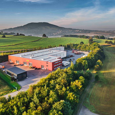 Aerial view of the DOLL plant in Mildenau, in a misty valley in the Black Forest